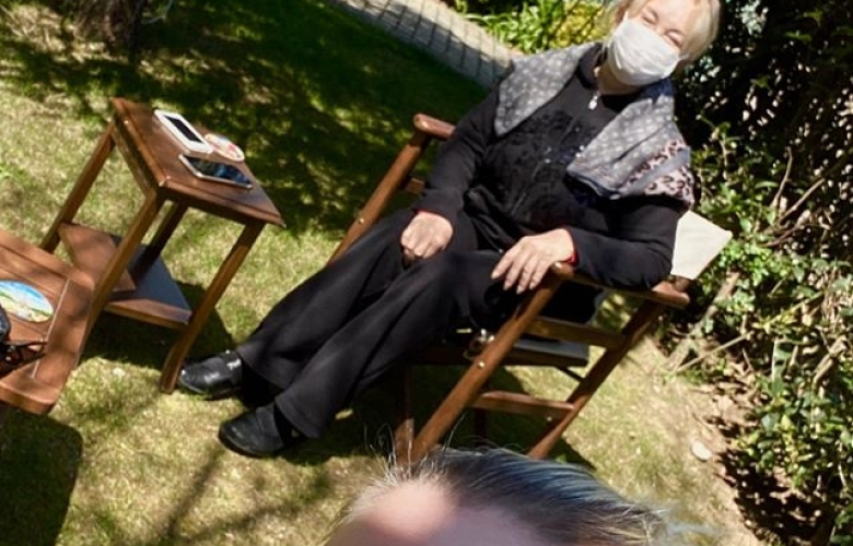 Emel Sayın evinin bahçesinde maskesini taktı